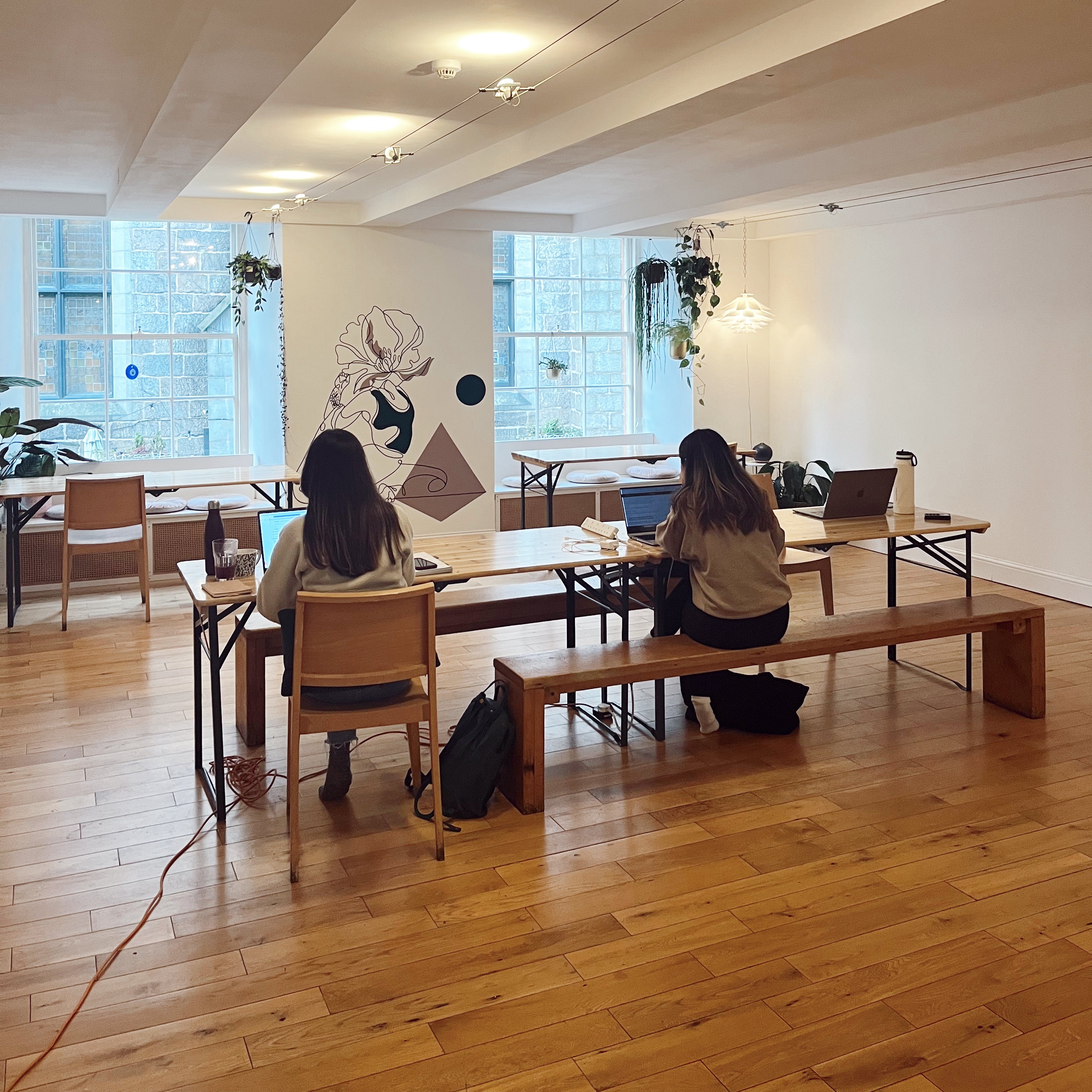 Modern office space with wooden floors and large windows